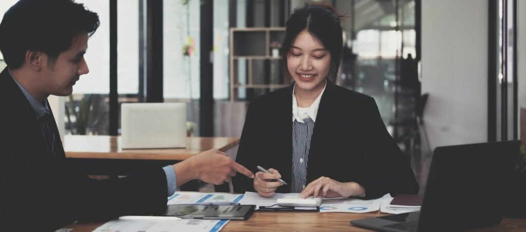 portrait of Asian supervisor boss teach diverse staff workers explain project plan paperwork at